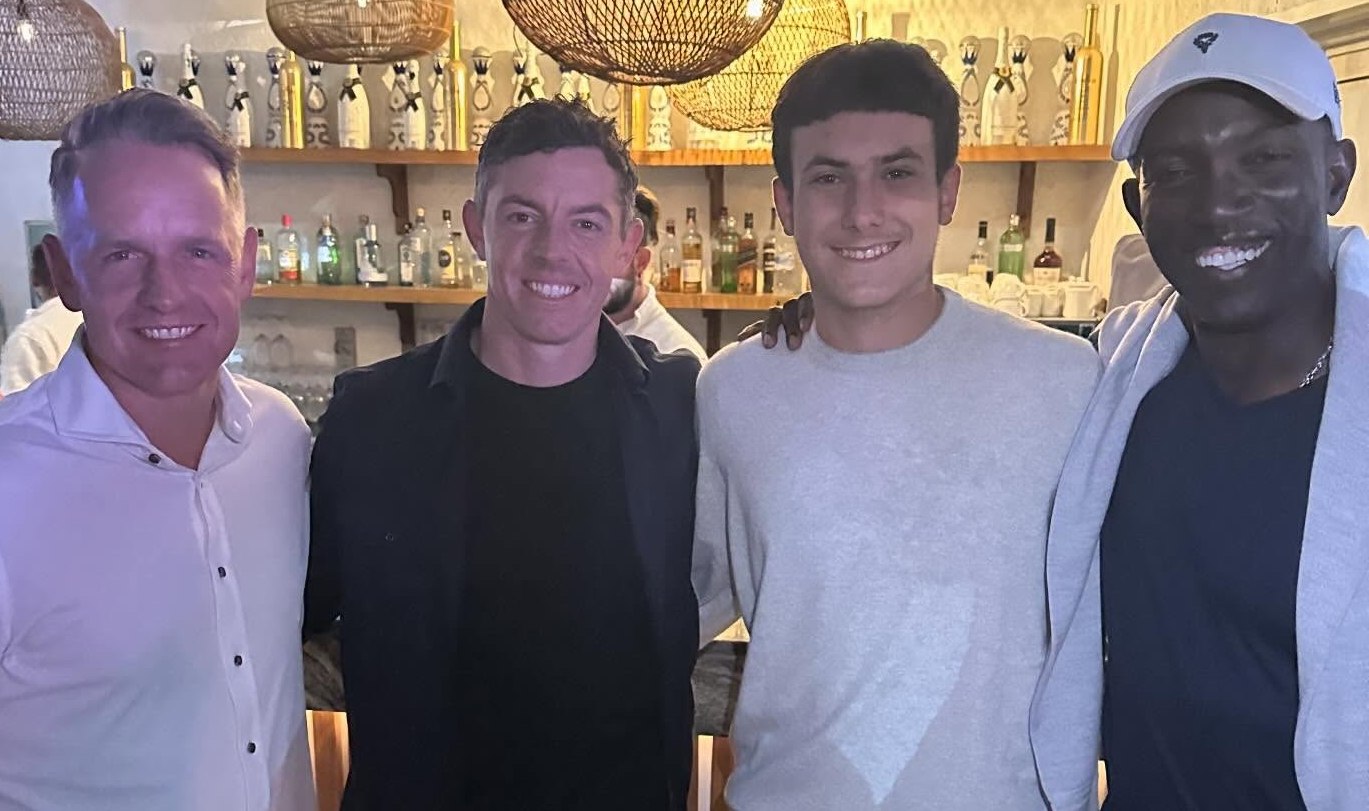 Rory McIlroy, Emanuele Galeppini, and two other men smiling in a bar.