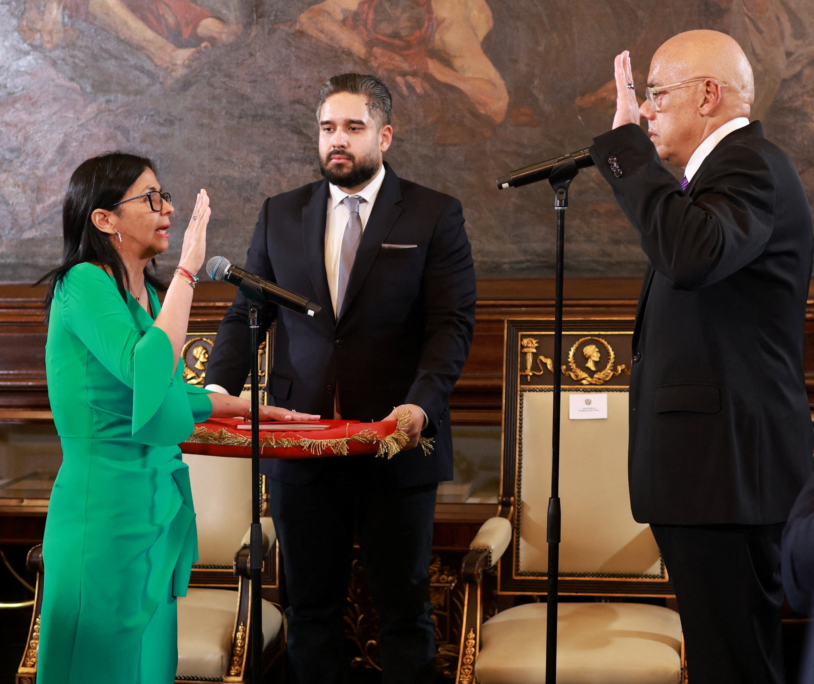 Delcy Rodríguez is sworn in as Venezuelan president in Caracas on Monday, as Nicolas Maduro Guerra, the son of the seized former president looks on