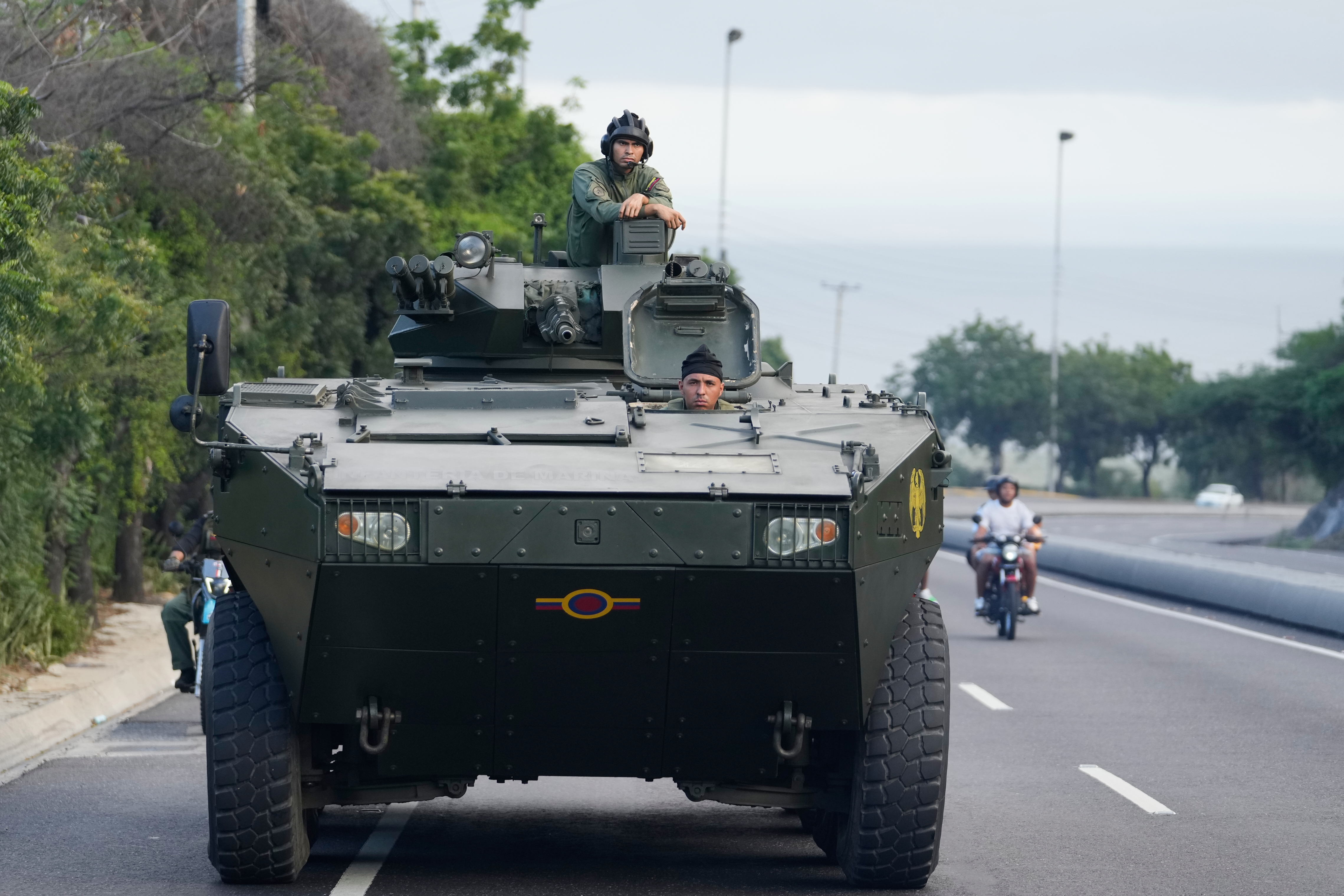 An armoured vehicle heads to Caracas on Sunday