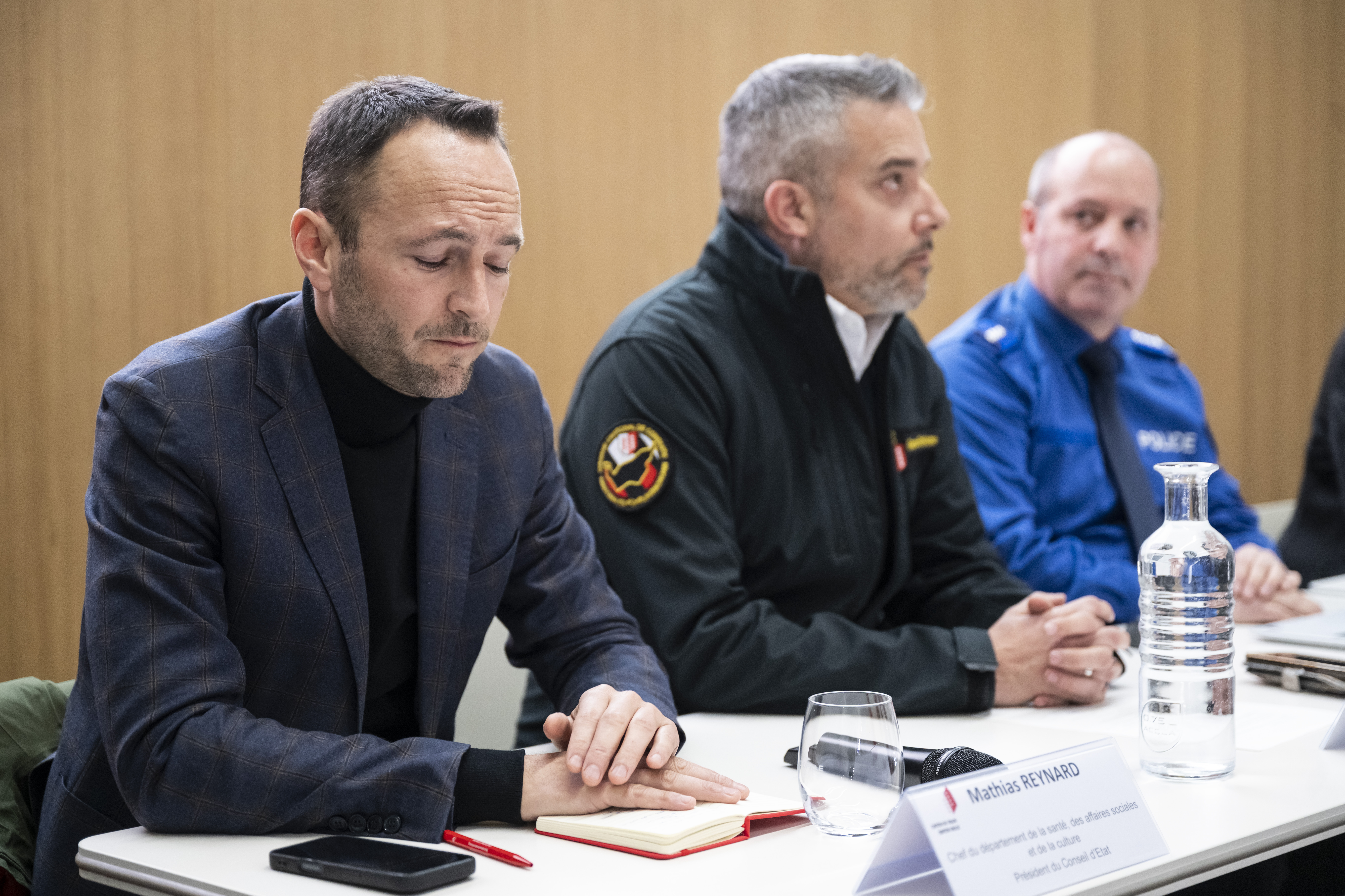 Mathias Reynard, Stephane Ganzer, and Frederic Gisler attending a press conference about a fire in a Swiss ski resort bar.