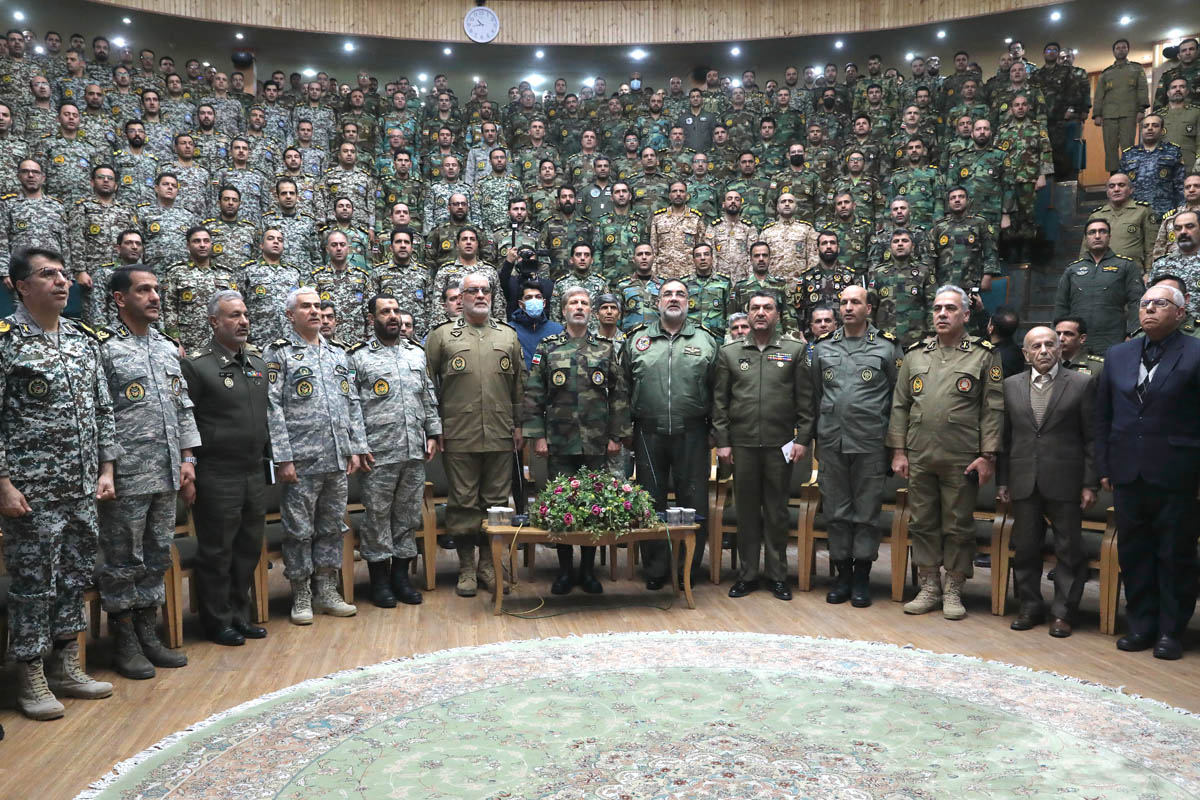 Iran's army chief Amir Hatami (C) with military officials and military academy students in Tehran.