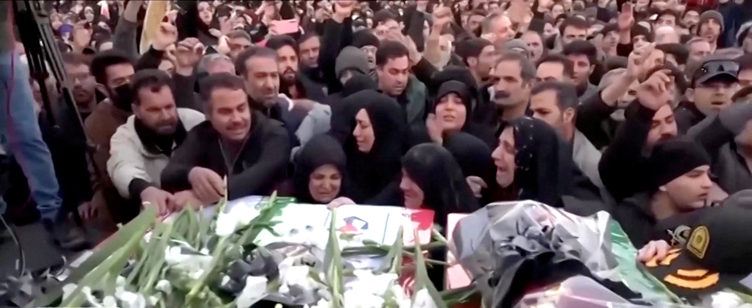 Mourners gather to bury their dead in Tehran