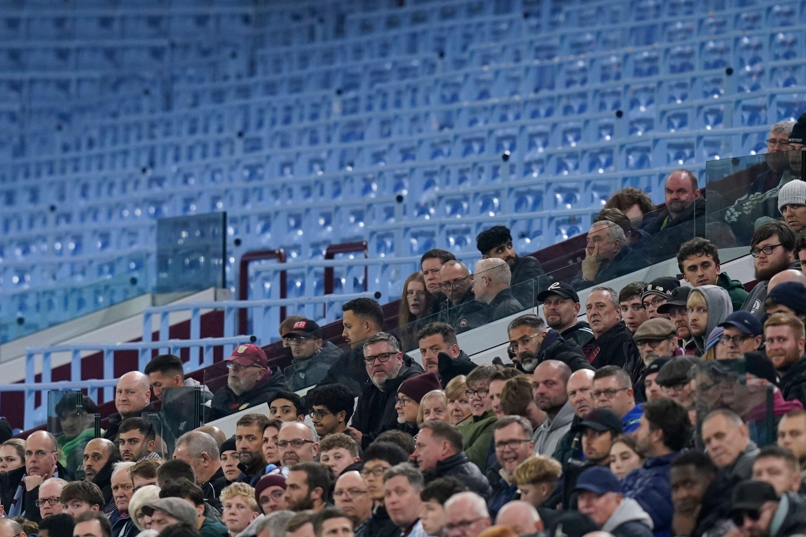 Aston Villa fans watching the UEFA Europa League match against Maccabi Tel-Aviv FC from stadium stands.