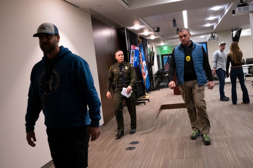 Gregory Bovino, center, departs after speaking during a press conference at the Bishop Henry Whipple Federal Building in Minneapolis, Minnesota, on January 22, 2026.