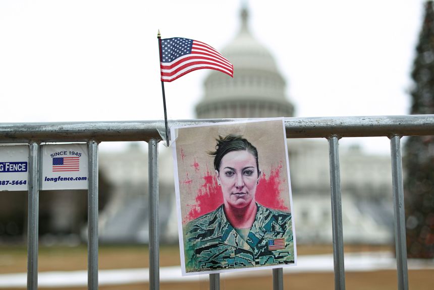 A portrait of Ashli Babbitt, who was shot dead during the January 6, 2021, attack on the US Capitol, hangs on a fence on January 6, 2022.