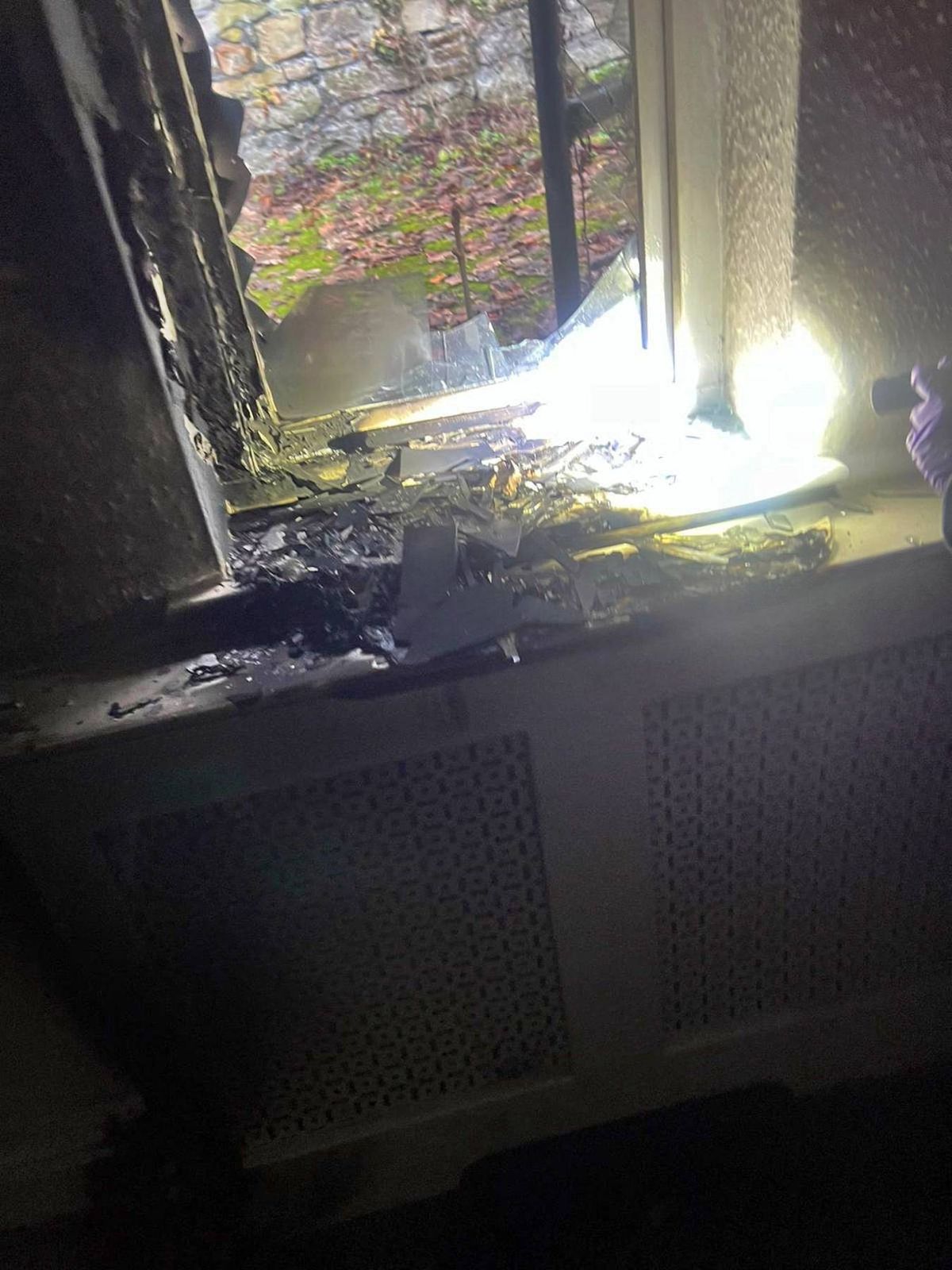 Charred remains where a window was smashed during an 'arson attack' at Oak Alyn Hall