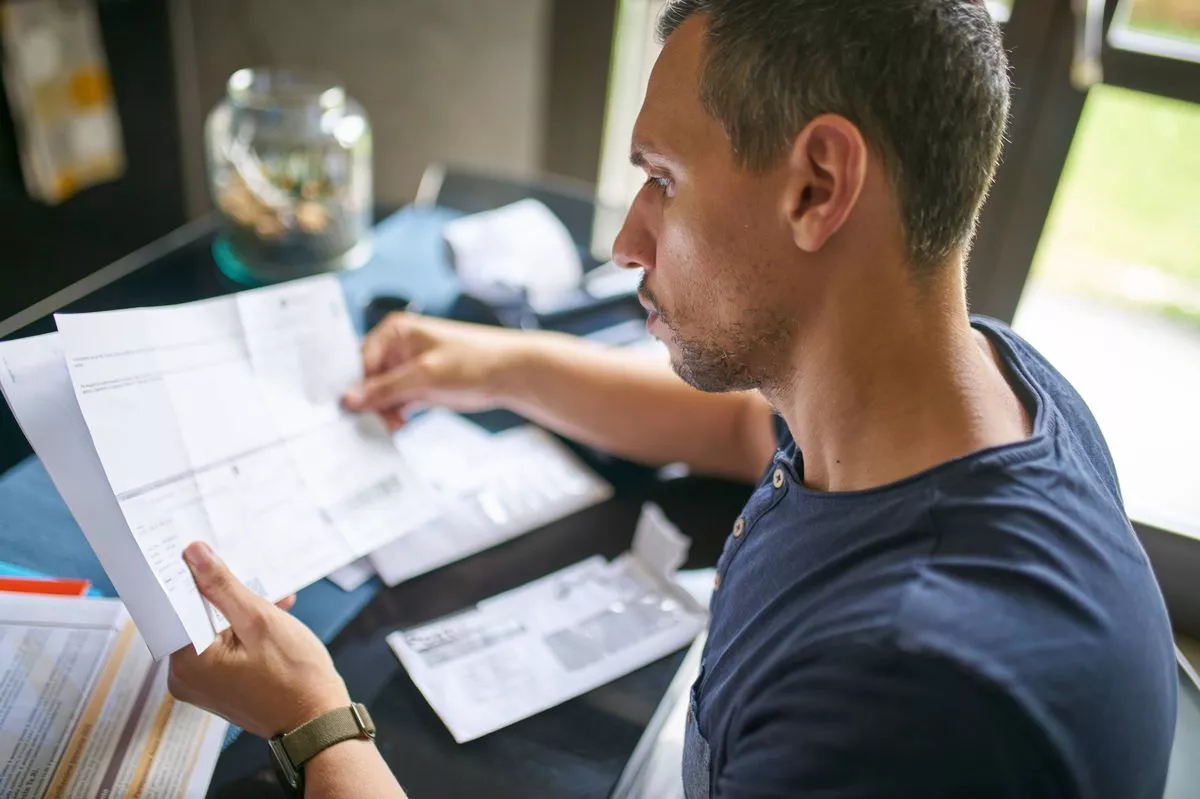 Man preparing his taxes at home