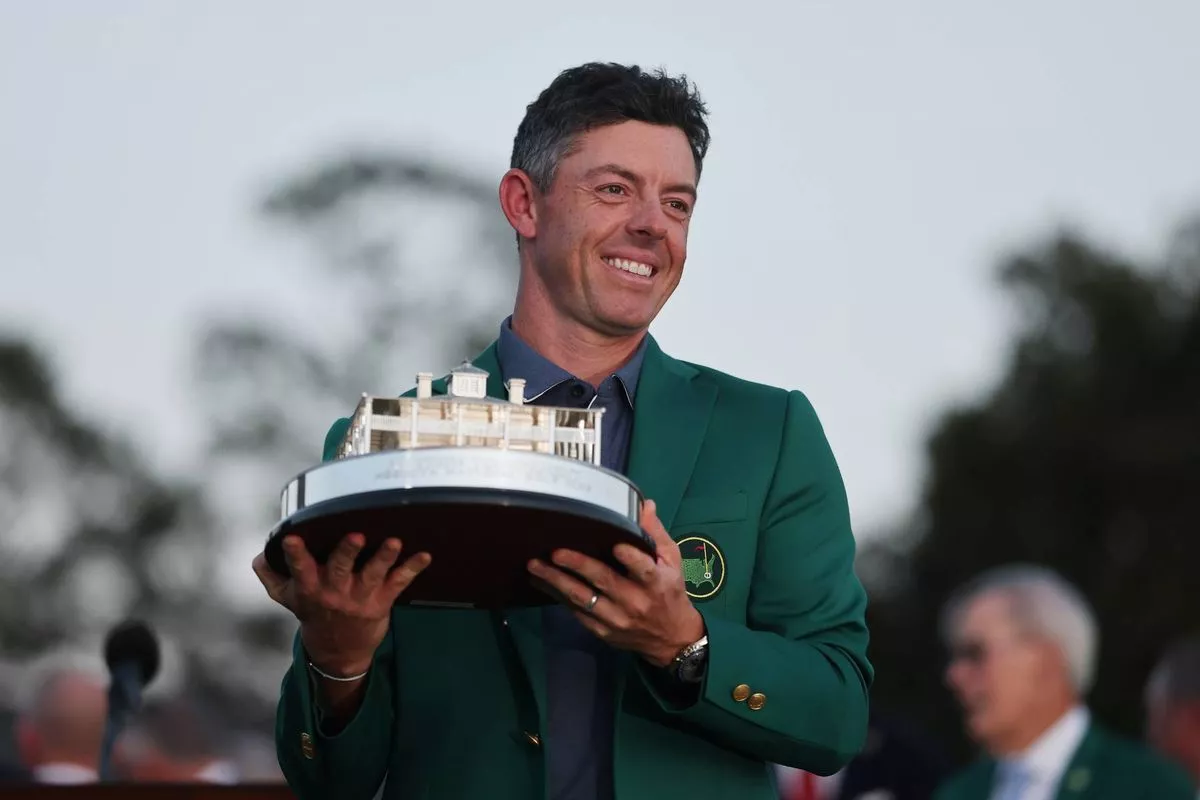 Rory McIlroy of Northern Ireland poses with the Masters trophy during the Green Jacket Ceremony after winning the 2025 Masters Tournament at Augusta National