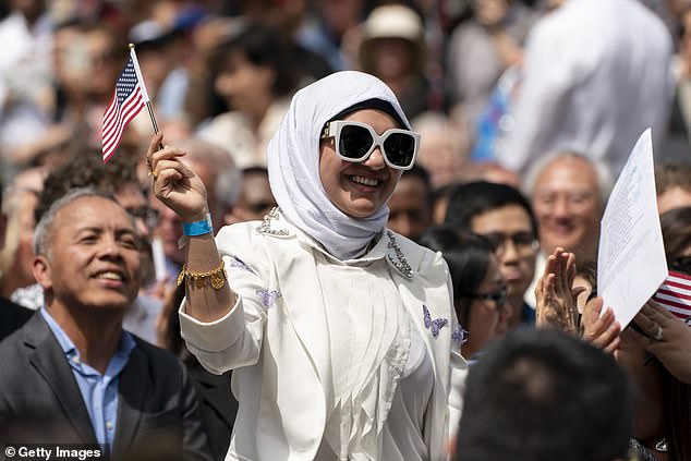 A sham marriage is one of the easiest routes scammers can take to get US citizenship, says Brown. Pictured: A naturalization ceremony for new US citizens at Seattle