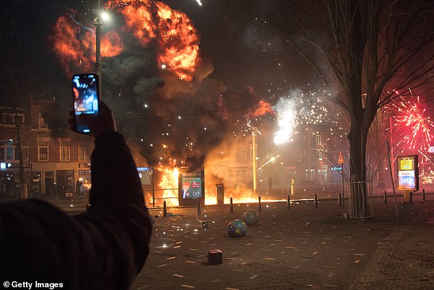 A tram stop is blown up with a makeshift explosive device as groups of residents from neighboring streets clash using fireworks in the Transvaal district on January 1, 2026 in The Hague