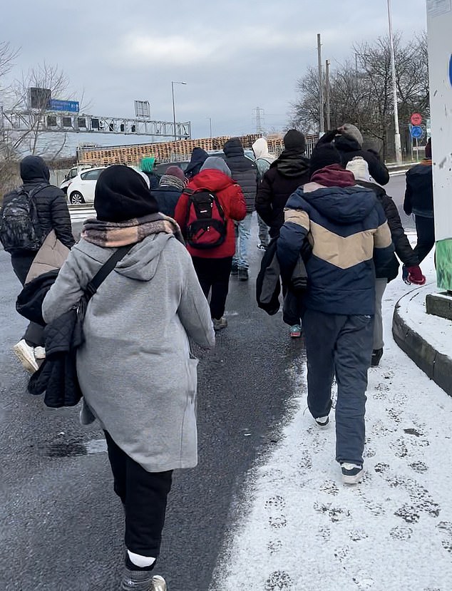 The group begins to walk away as a lorry driver asks them: 'Where have you come from?'