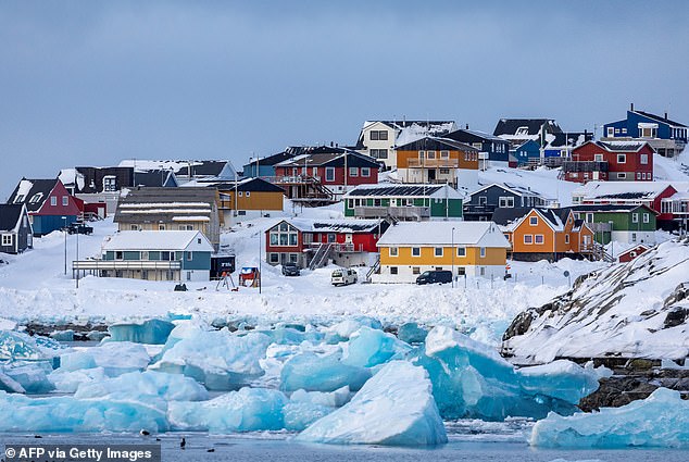 Colorful houses line the snowy coast of Nuuk, the capital city of Greenland. The city has a population of around 20,000