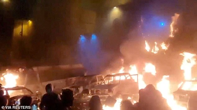 Protesters gather as vehicles burn, amid evolving anti-government unrest, in Tehran, Iran