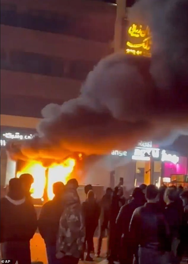 Picture shows a building on fire during the protests in Tehran