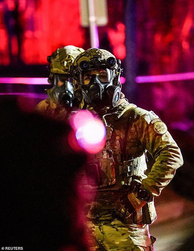 Federal law enforcement officers clashes with protesters on the street in the aftermath of the shooting