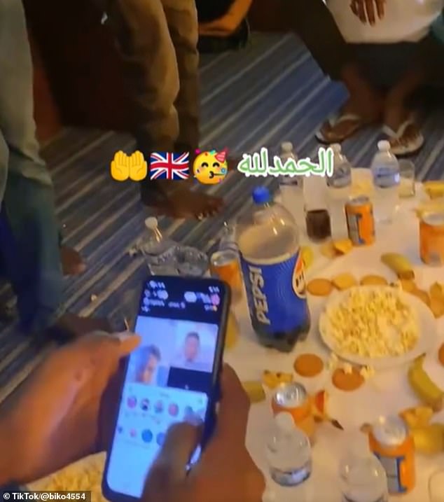 Suspected migrants have shared a video of themselves eating food at a social gathering in what is suspected to be temporary accommodation in Britain