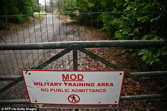 Signage warning unauthorised people to stay out is pictured at a gate outside the Crowborough Training Camp in Crowborough, south-east England on December 11, 2025