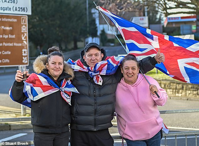 A group of people wave Union Jacks from an anti-immigration protest