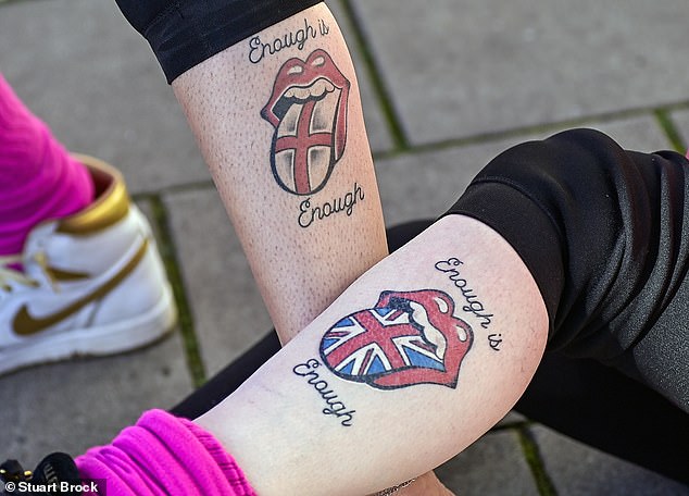 Some demonstrators have 'Enough is Enough' tattoos on their lower legs