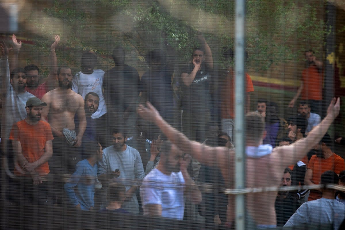 Detainees at Brook House shout and chant in unison with protesters outside the centre against the UK deportation flights to Rwanda in 2022 (Getty)
