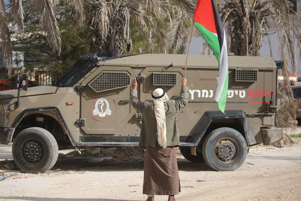 Palestinian residents of Nur Shams refugee camp and foreign activists gather at the camp's entrance during a protest demanding their right to return to their homes, December 15, 2025. (Photo: Mohammed Nasser/APA Images)