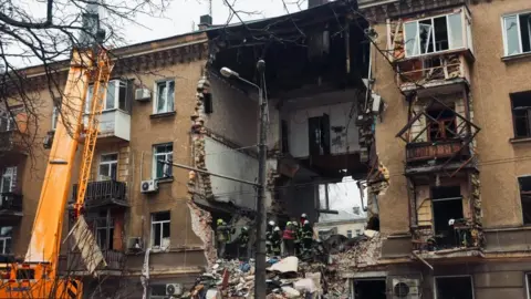 EPA/Shutterstock Rescuers search through the rubble of a destroyed residential building in Odesa, southern Ukraine. Photo: 27 January 2026