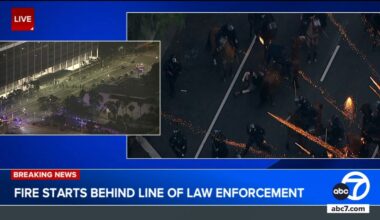 Small fire erupts behind LAPD skirmish line during immigration protests