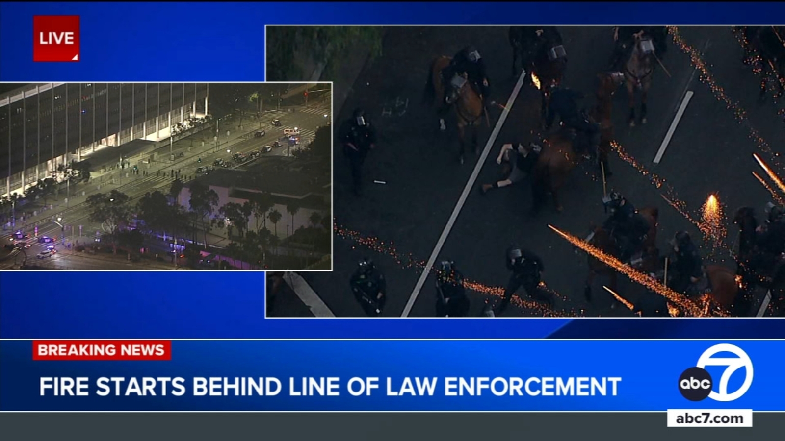 Small fire erupts behind LAPD skirmish line during immigration protests