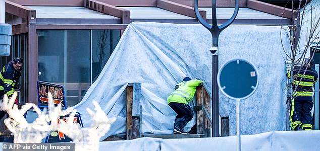 Rescuers and fire-fighters work at the site of an explosion that ripped through a bar in Crans-Montana on January 1, 2026. Several people were killed and others injured when an explosion ripped through a bar in the luxury Alpine ski resort town of Crans Montana, Swiss police said early on January 1. (Photo by MAXIME SCHMID / AFP via Getty Images)