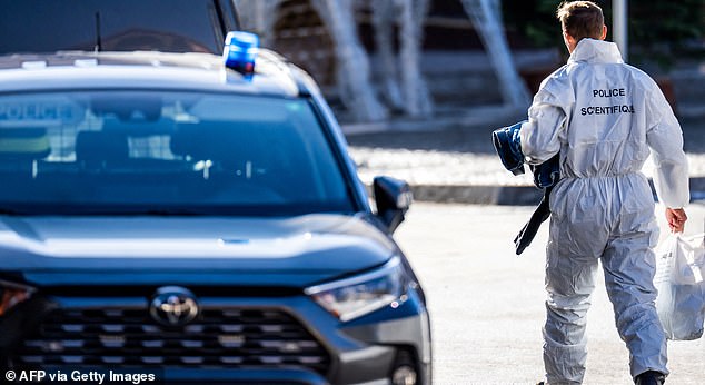 A member of the forensic police arrives at the bar Le Constellation following an explosion that ripped the venue in Crans-Montana, in January 1, 2026 during New Year's Eve celebrations. Several dozen people are presumed dead and around 100 injured after a fire ripped through a crowded bar in the luxury Swiss ski resort town of Crans-Montana, police said early January 1, 2026. (Photo by MAXIME SCHMID / AFP via Getty Images)