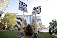 Community members chant during a "No War on Venezuela" protest at Civic Garden Park in...