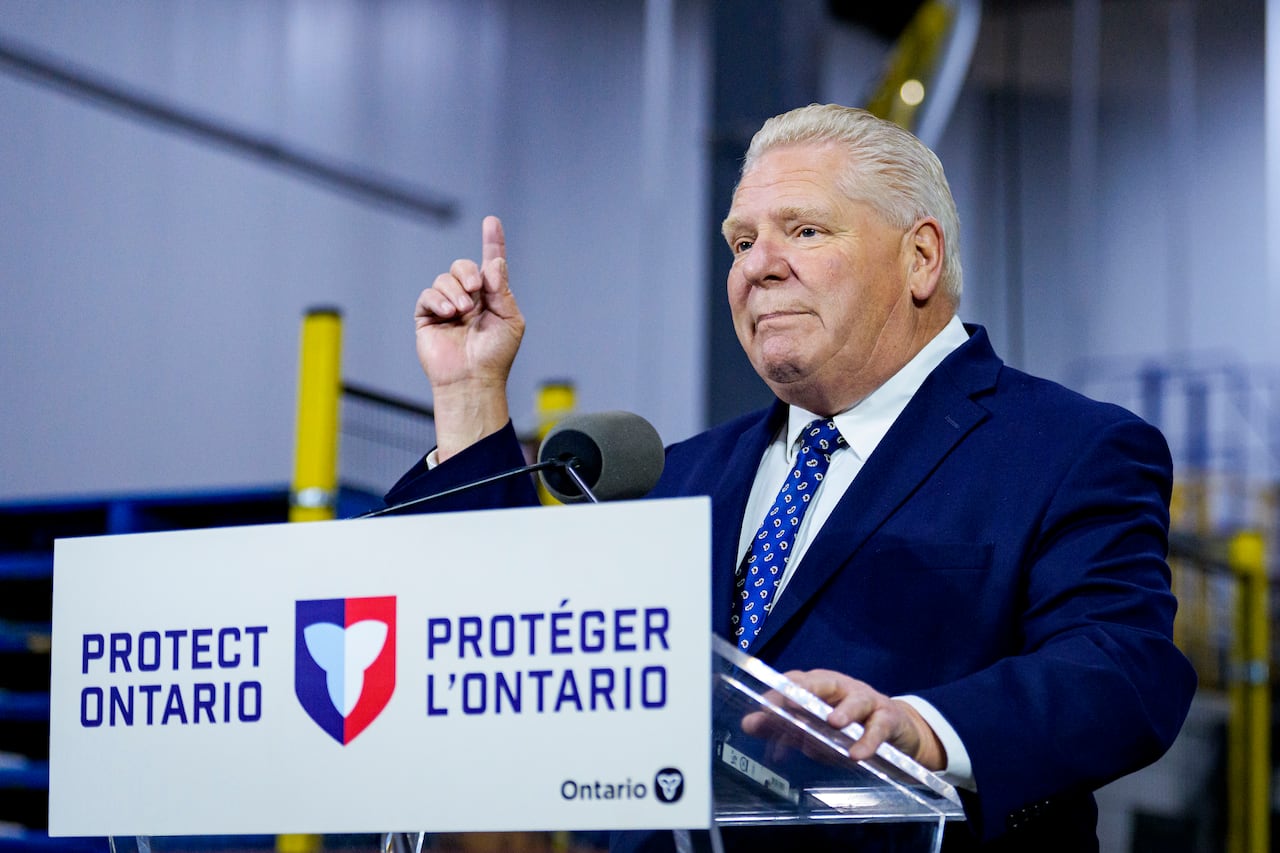 A man stands at a podium that says "Protect Ontario" and gestures with his right hand.