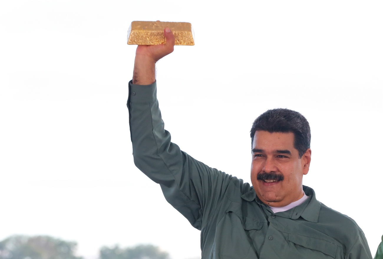 A handout photo made available by the Miraflores Palace shows Venezuelan President Nicolas Maduro holding a gold ingot.