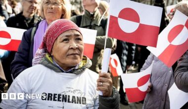 Young women walk on a snowy street in Nuuk, Greenland