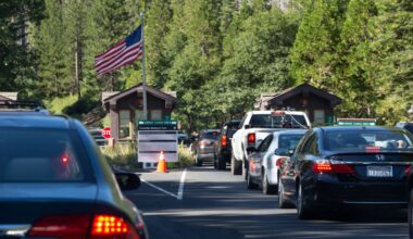 A long line of cars creeps slowly entrance of Yosemite National Park