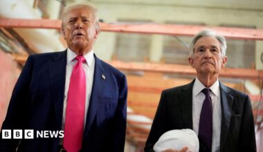 Donald Trump appears next to Jerome Powell, who is carrying a white hard hat, during a visit to the Federal Reserve building as it undergoes renovations.