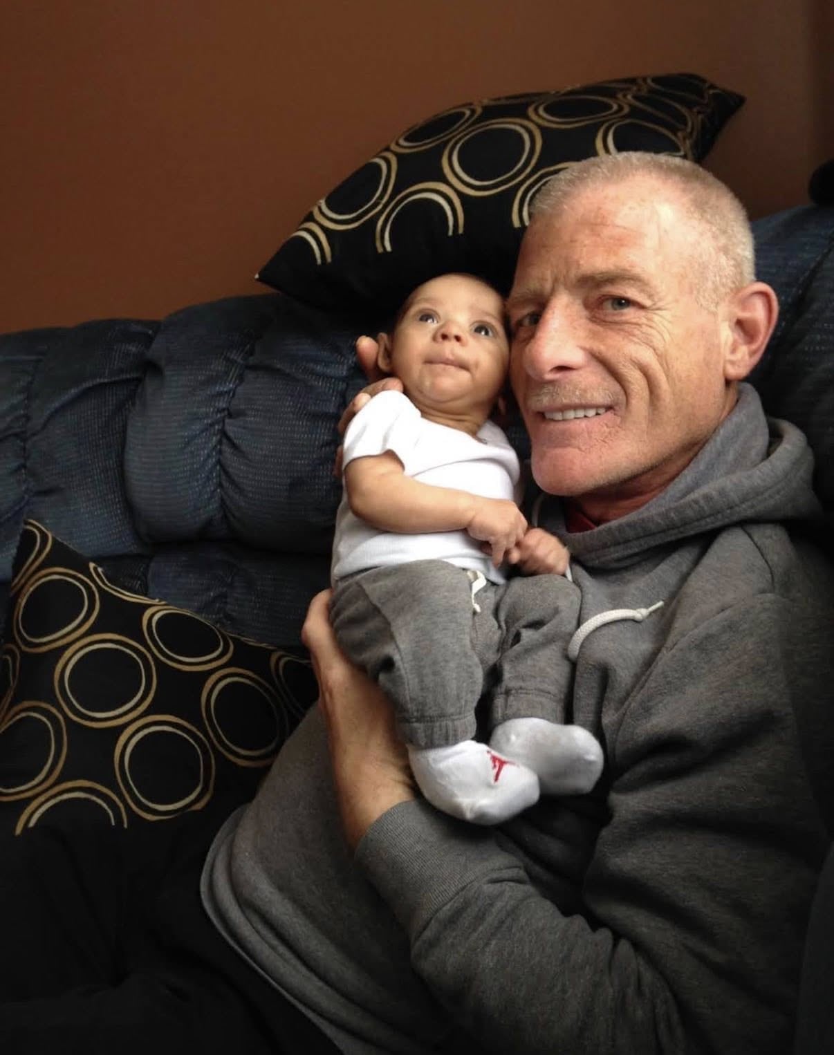 smiling ron snook with a baby