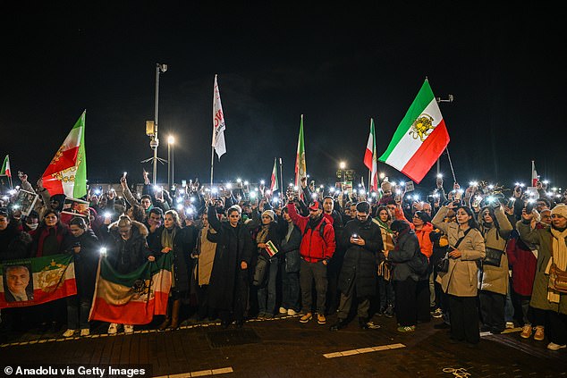 AMSTERDAM, NETHERLANDS Ã¢" JANUARY 14: People gather at Dam Square in Amsterdam during a solidarity rally for Iran on January 14, 2026. The demonstration comes amid ongoing unrest in Iran, where protests have continued in response to political repression and worsening living conditions. Participants carried flags, held signs and chanted slogans calling for freedom and accountability, as concerns persist over reported casualties and arrests linked to the unrest. (Photo by Mouneb Taim/Anadolu via Getty Images)