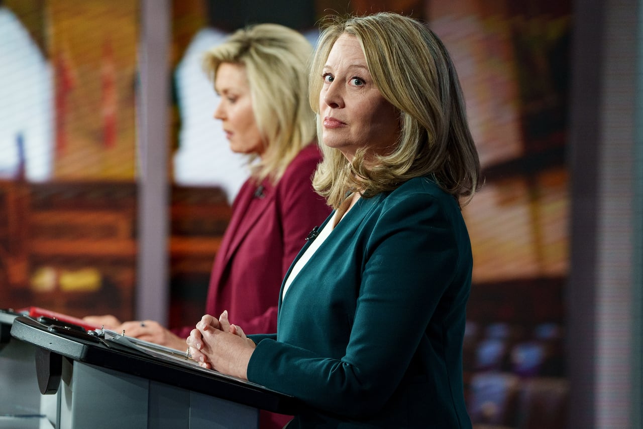 Two women standing at podiums.