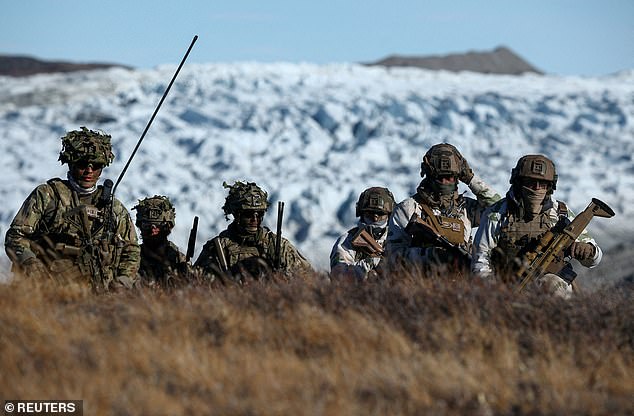 FILE PHOTO: Members of the Danish armed forces practice looking for potential threats during a military drill as Danish, Swedish and Norwegian home guard units together with Danish, German and French troops take part in joint military drills in Kangerlussuaq, Greenland, September 17, 2025. REUTERS/Guglielmo Mangiapane/File Photo