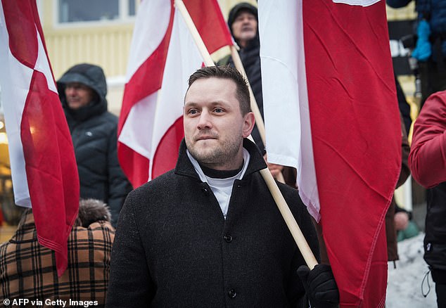 Greenlandic Prime Minister Jens-Frederik Nielsen takes part in a demonstration that gathered almost a third of the city population to protest against the US President's plans to take Greenland, on January 17, 2026 in Nuuk, Greenland. US President Donald Trump escalated his quest to acquire Greenland, threatening multiple European nations with tariffs of up to 25 percent until his purchase of the Danish territory is achieved. Trump's threats came as thousands of people protested in the capital of Greenland against his wish to acquire the mineral-rich island at the gateway to the Arctic. (Photo by Alessandro RAMPAZZO / AFP via Getty Images)