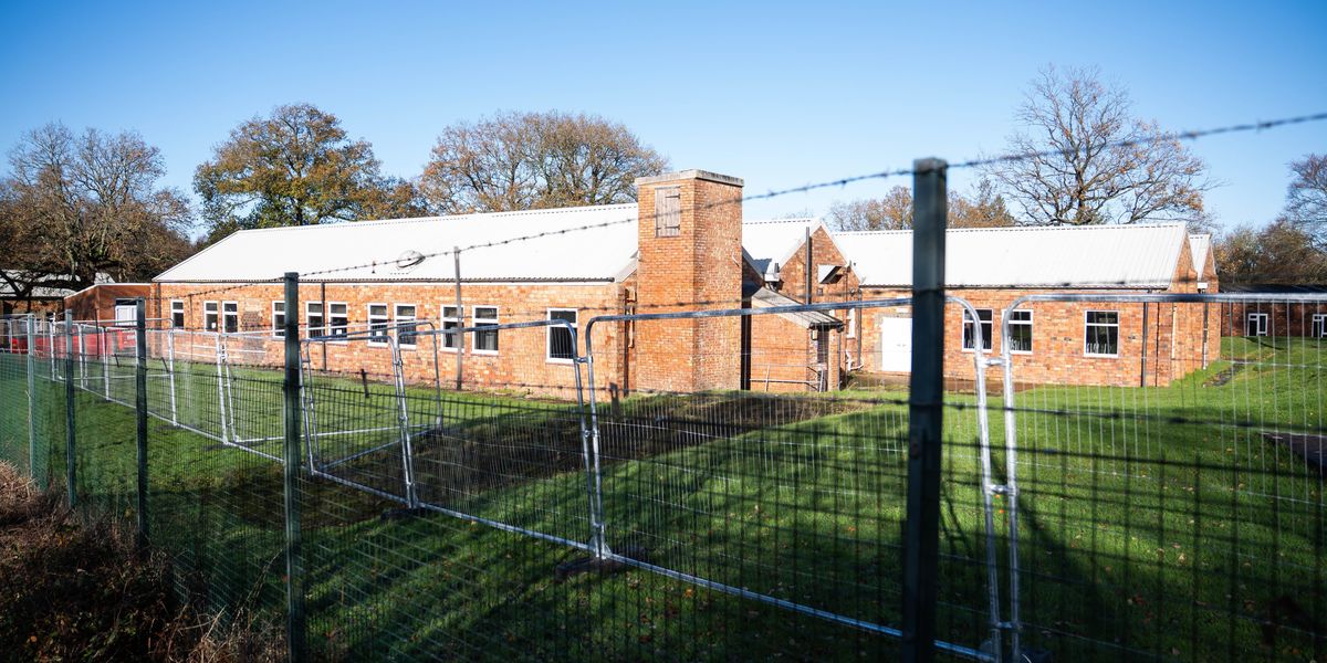 First migrants bussed into army camp in dead of night despite furious local protests