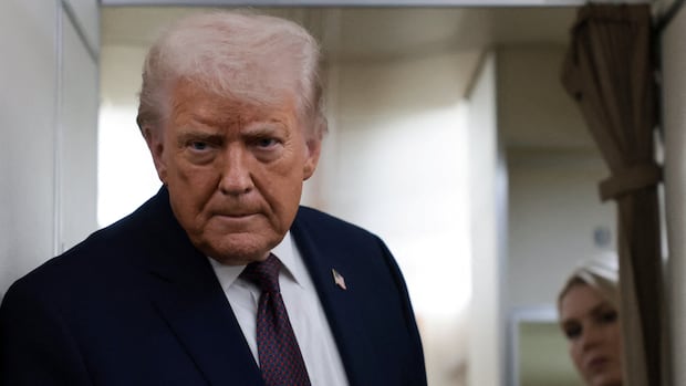 A man in a suit on a plane.