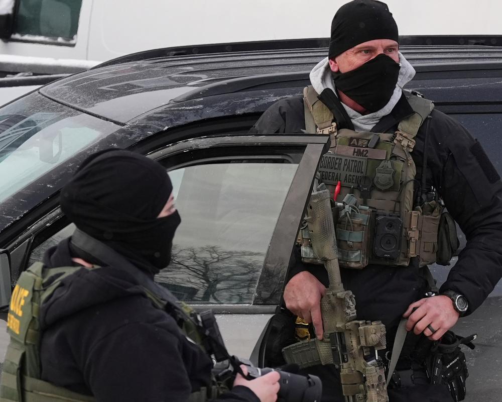 Immigration Enforcement MinnesotaFederal immigration agents work on the scene in Minneapolis, Sunday, Jan. 25, 2026. (AP Photo/Adam Gray)