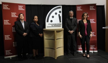 The Bulletin of the Atomic Scientist members, from left, Jon B. Wolfsthal, Asha M. George, Steve Fetter and Alexandra Bell, reveal the Doomsday Clock, set to 85 seconds to midnight, during a news conference at the Carnegie Endowment for International Peace, Friday, Jan. 23, 2026, in Washington. (AP Photo/Pablo Martinez Monsivais)