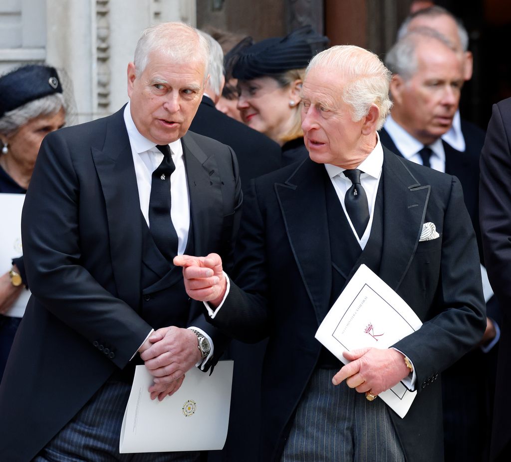 Prince Andrew speaking with King Charles at a funeral