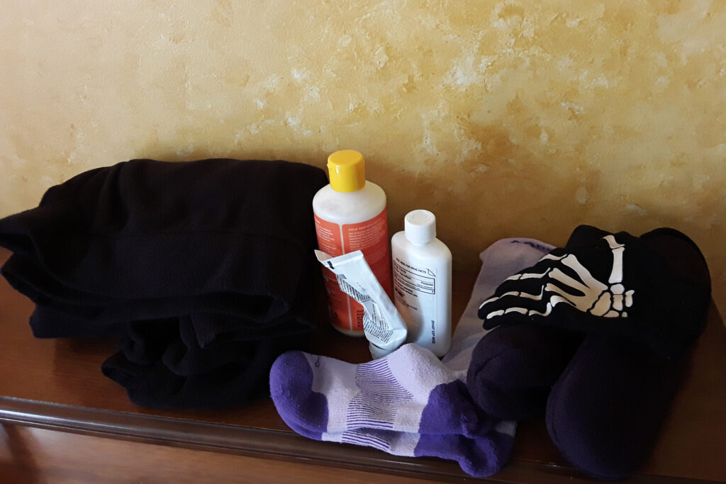 An assortment of items that Dawn Gibson to mange her pain: a warm hoodie, compression socks, topical pain medications and a drug-free shea butter lotion. Credit: Courtesy of Dawn Gibson