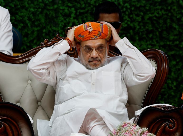 India's Home Minister Amit Shah adjusts his turban during an inauguration ceremony of Gopalanand Swami Yatrik Bhavan at a temple premises in Salangpur, in the western state of Gujarat, India, October 31, 2024. REUTERS/Amit Dave