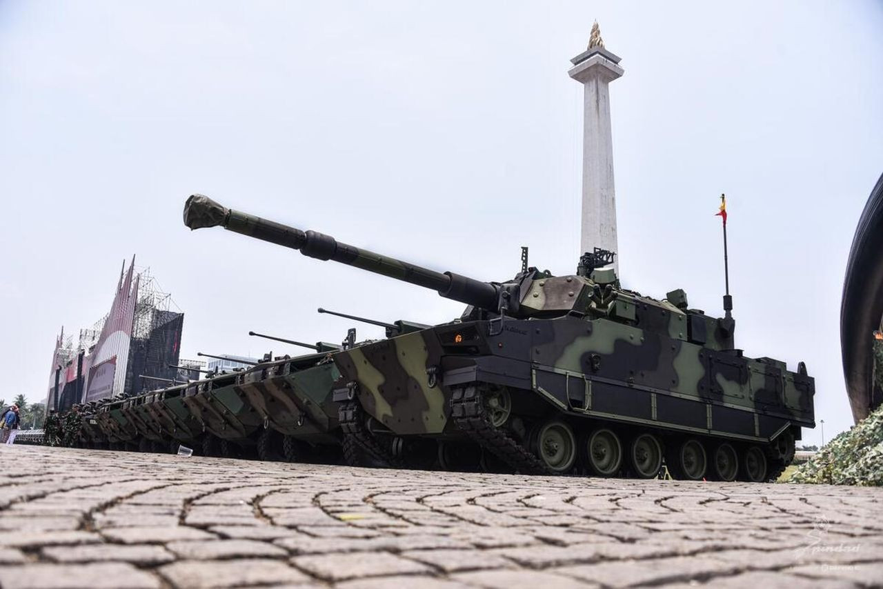 A Harimau medium tank (front), made by state-owned land weapons and ammunition maker PT Pindad, is parked next to Pandur II 8x8 armored combat vehicle against the backdrop of the National Monument (Monas) at Merdeka Square in Central Jakarta on Oct. 2, 2024, ahead of an event to mark the 79th anniversary of the Indonesian Military (TNI).