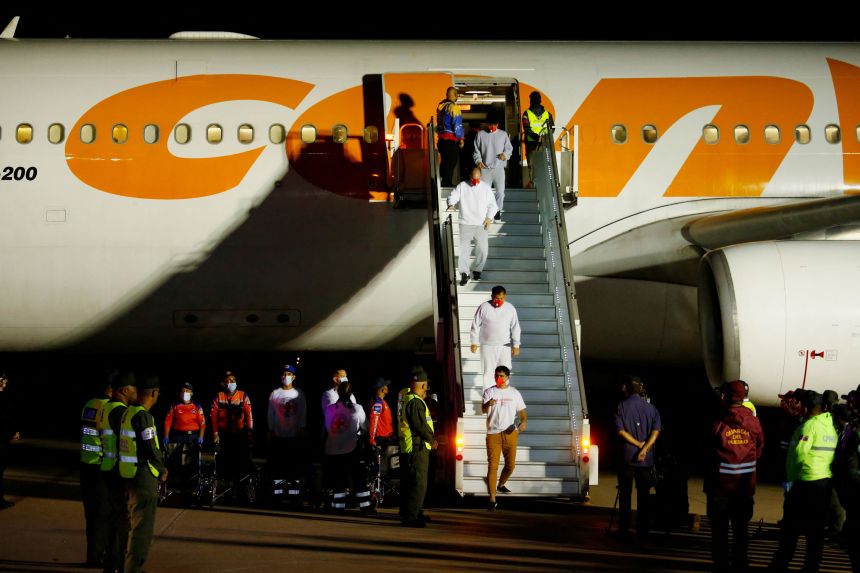 Venezuelan migrants walk following their arrival on a flight after being deported from the United States, in Caracas, Venezuela, March 28, 2025.